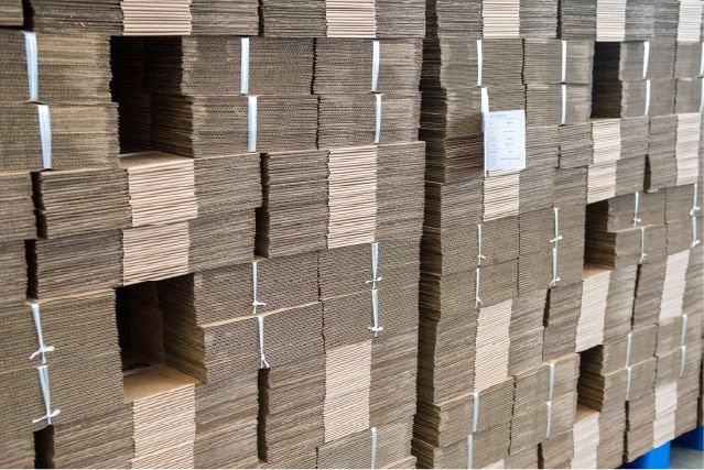 Stacks of cardboard boxes for packaging and shipping, ready for distribution.