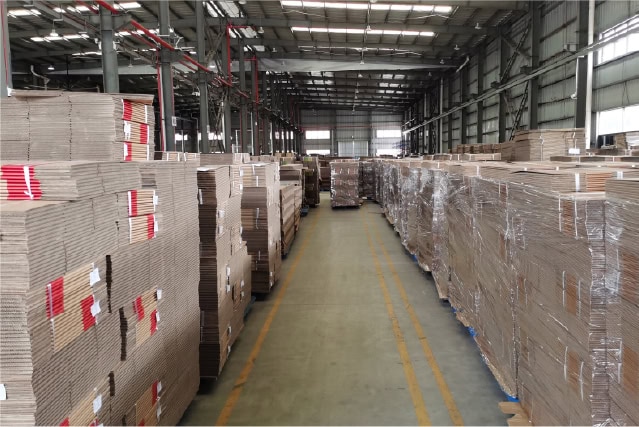1. Corrugated cardboard boxes stacked in a warehouse for packaging and shipping solutions.